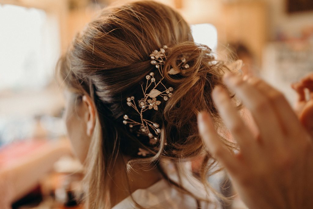 Closeup of Hairstylist doing Bride's hair