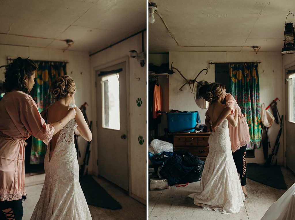 Bride getting help putting dress on getting ready