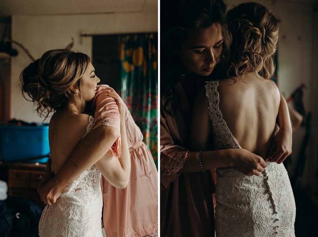 Bride hugging mother after getting dress on