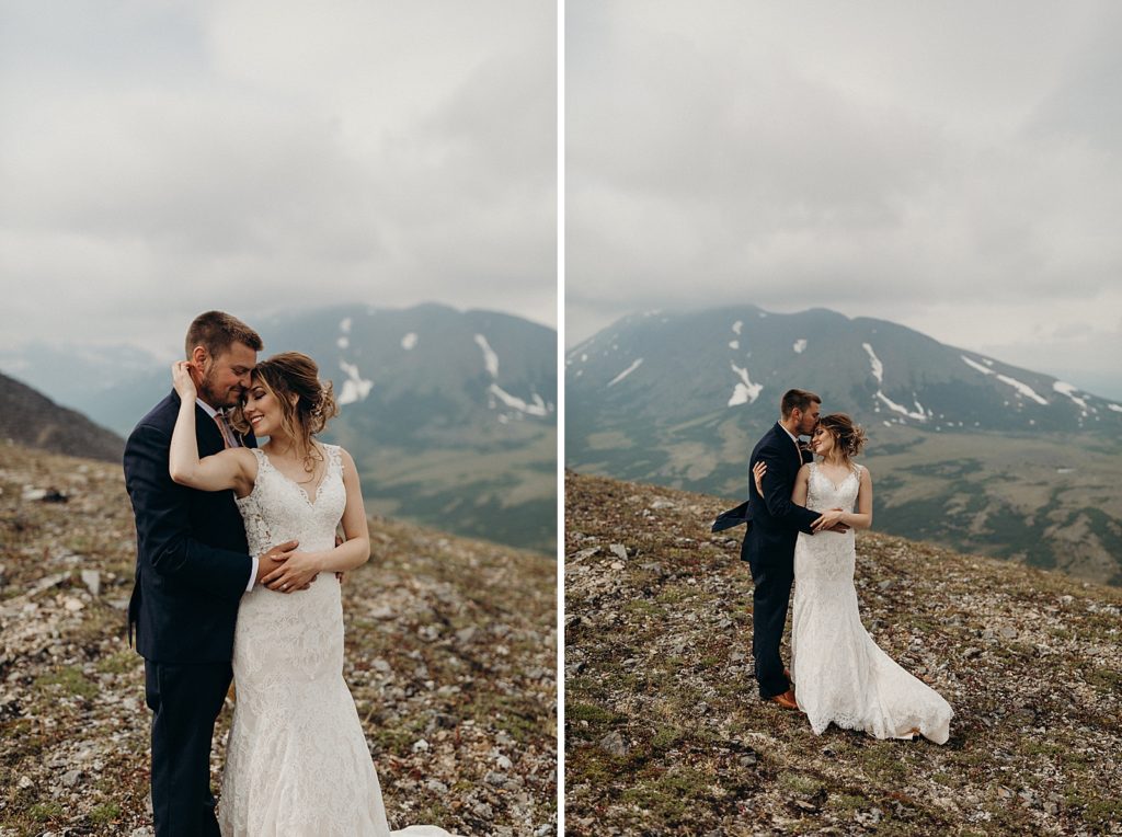 Bride and Groom posing with mountain drop