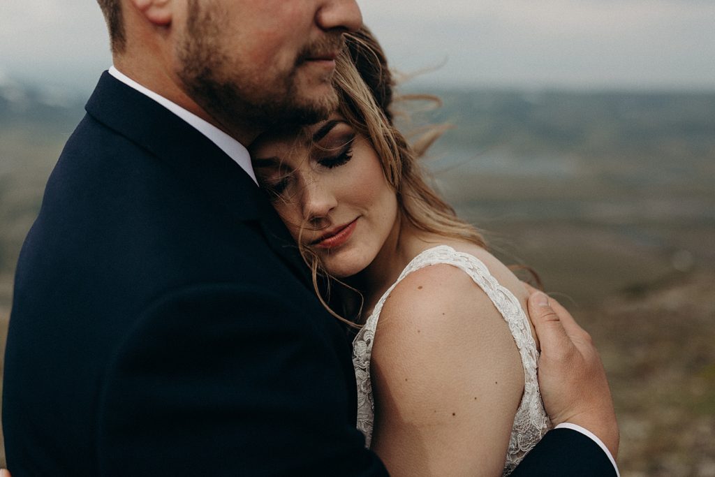 Groom holding Bride against his chest