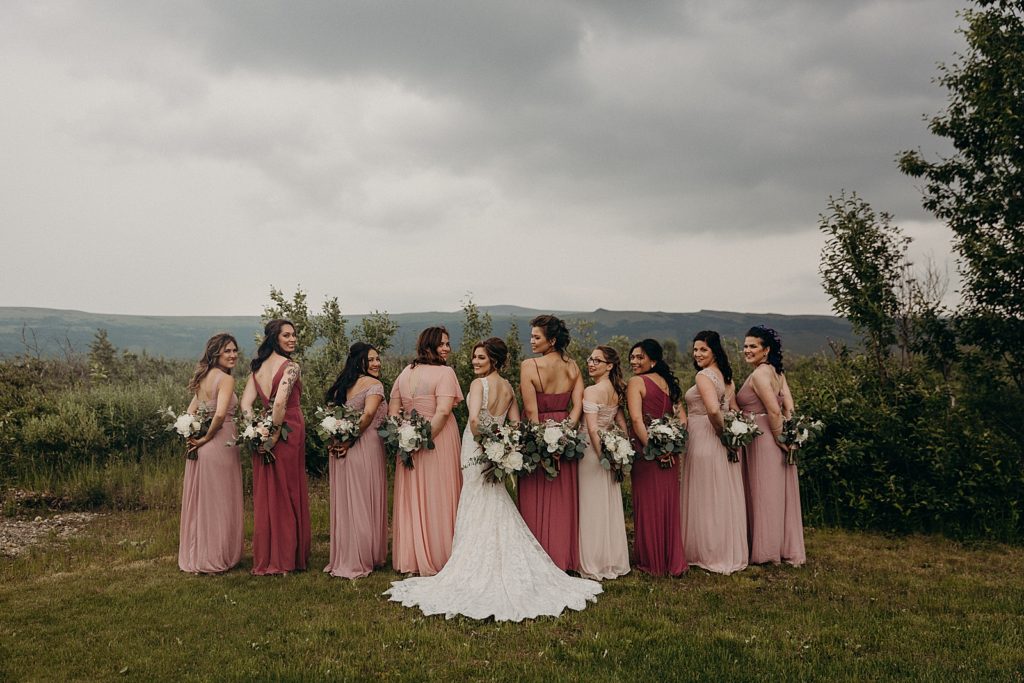 Bride and Bridesmaids holding bouquets behind their backs