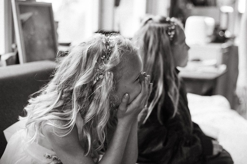 B&W flower girls sitting and laughing