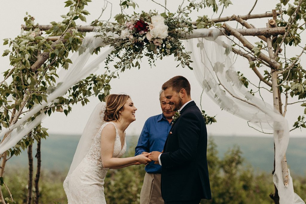 Bride and Groom laughing during Homily Ceremony