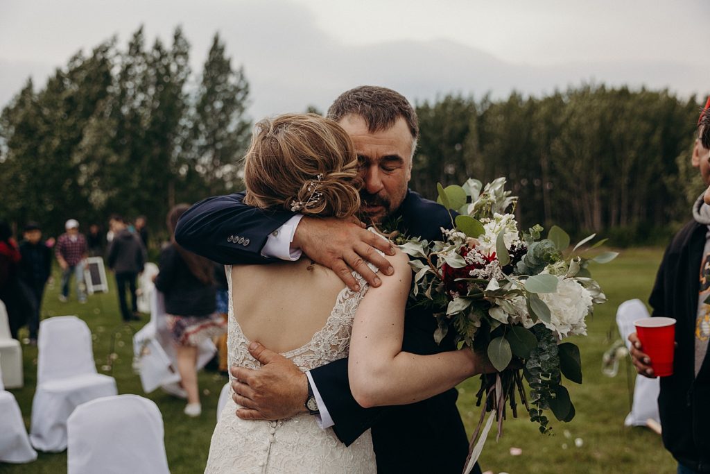 Father hugging Bride after Ceremony