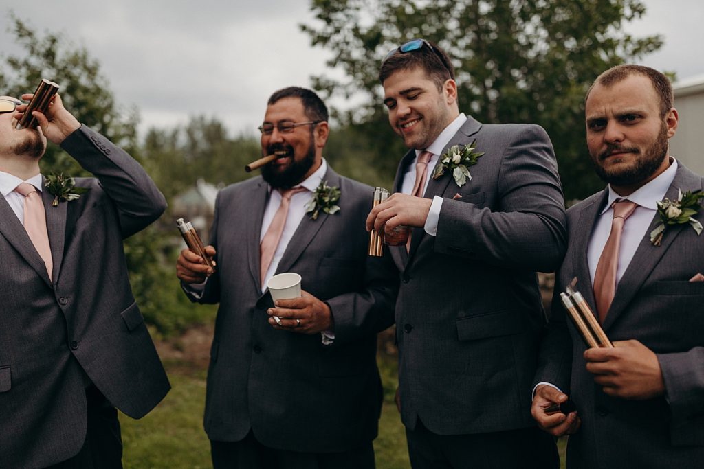 Groom having a drink with Groomsmen