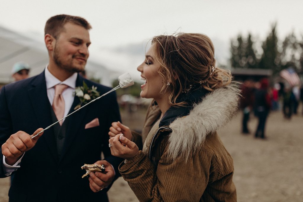 Groom giving Bride toasted Marshmellow