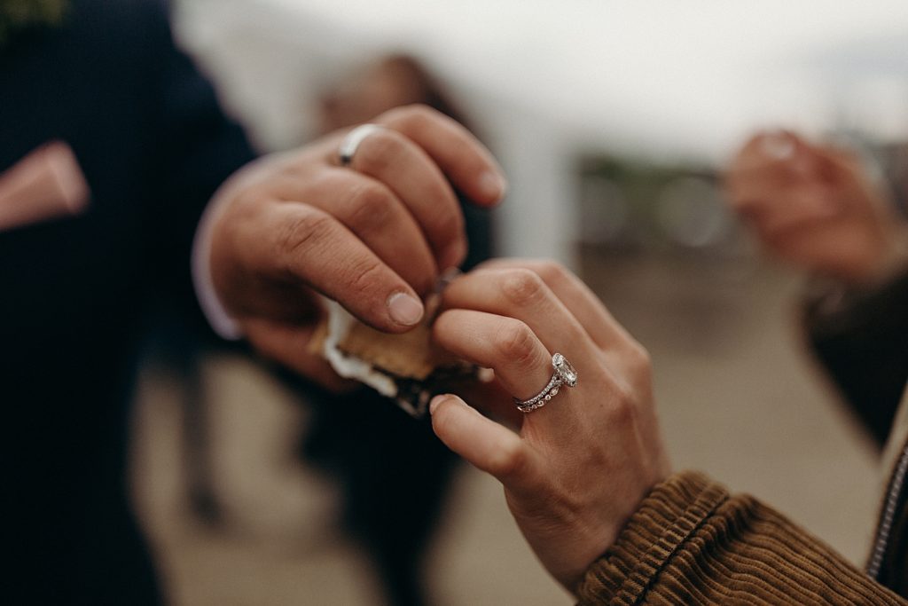 Closeup of Bride and Groom splitting a S'more